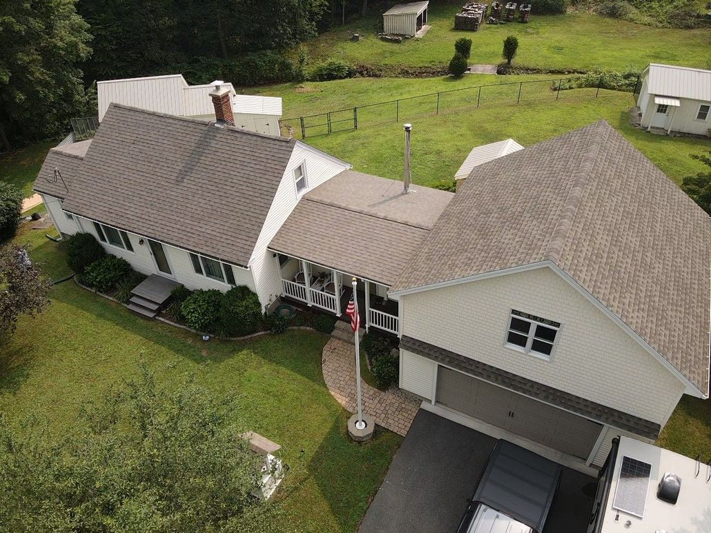 White house, brown roof. Roof replacement. Western Mass.