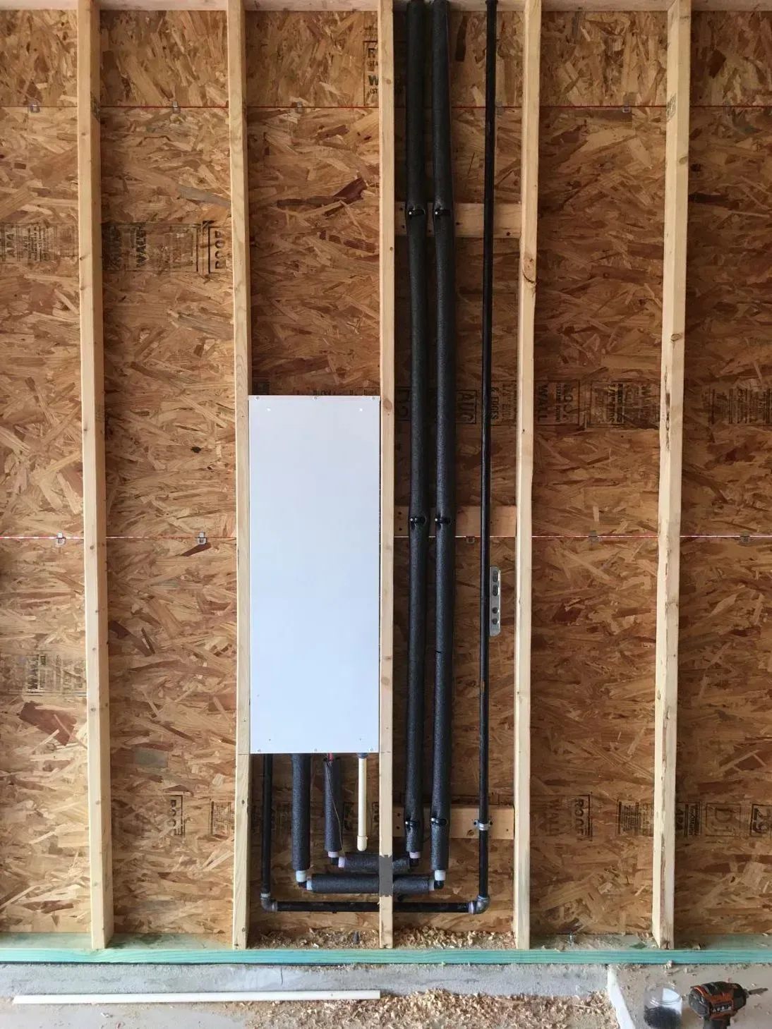 A wooden wall with pipes coming out of it