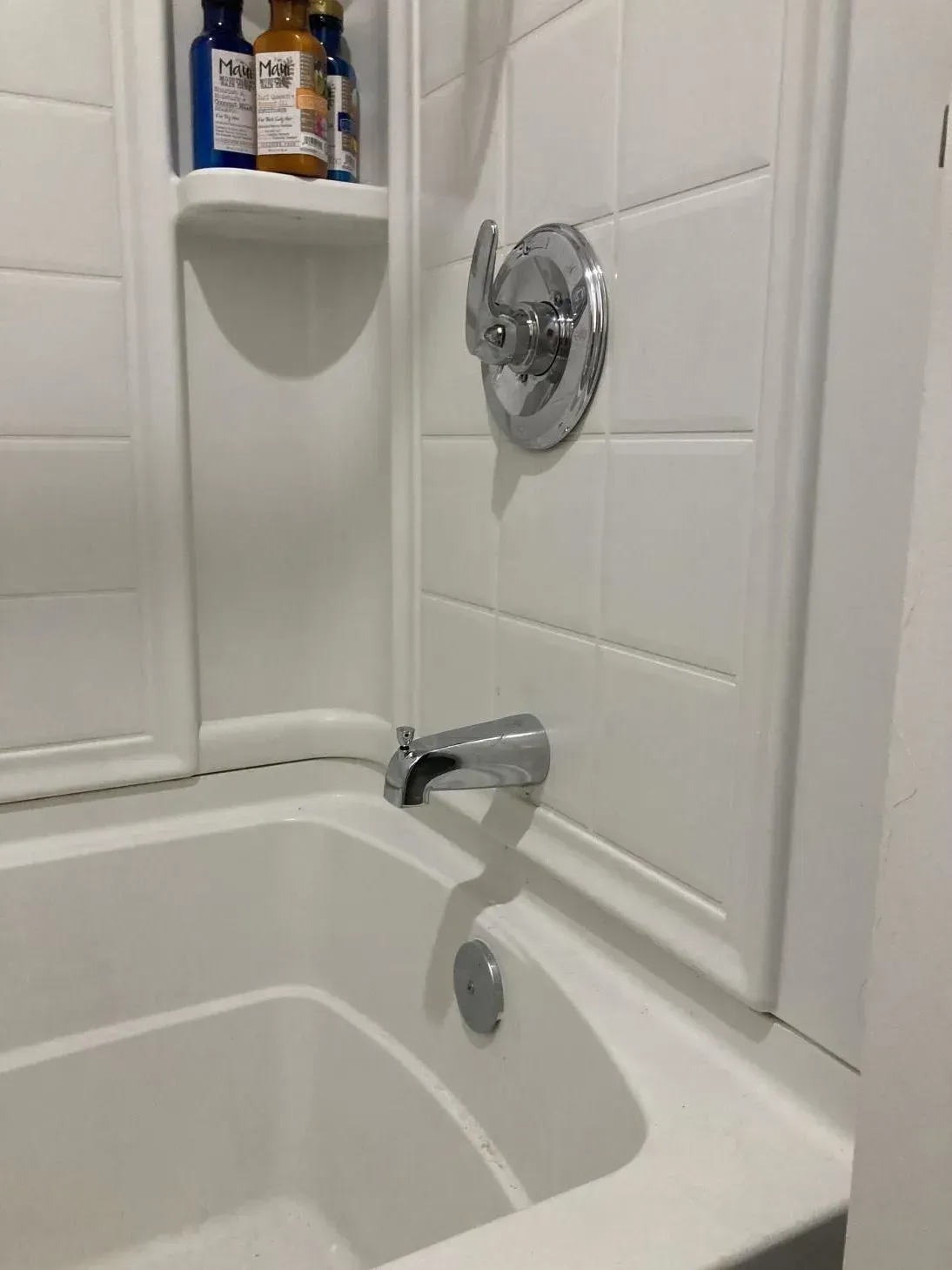 A bathroom with a bathtub and a shower stall
