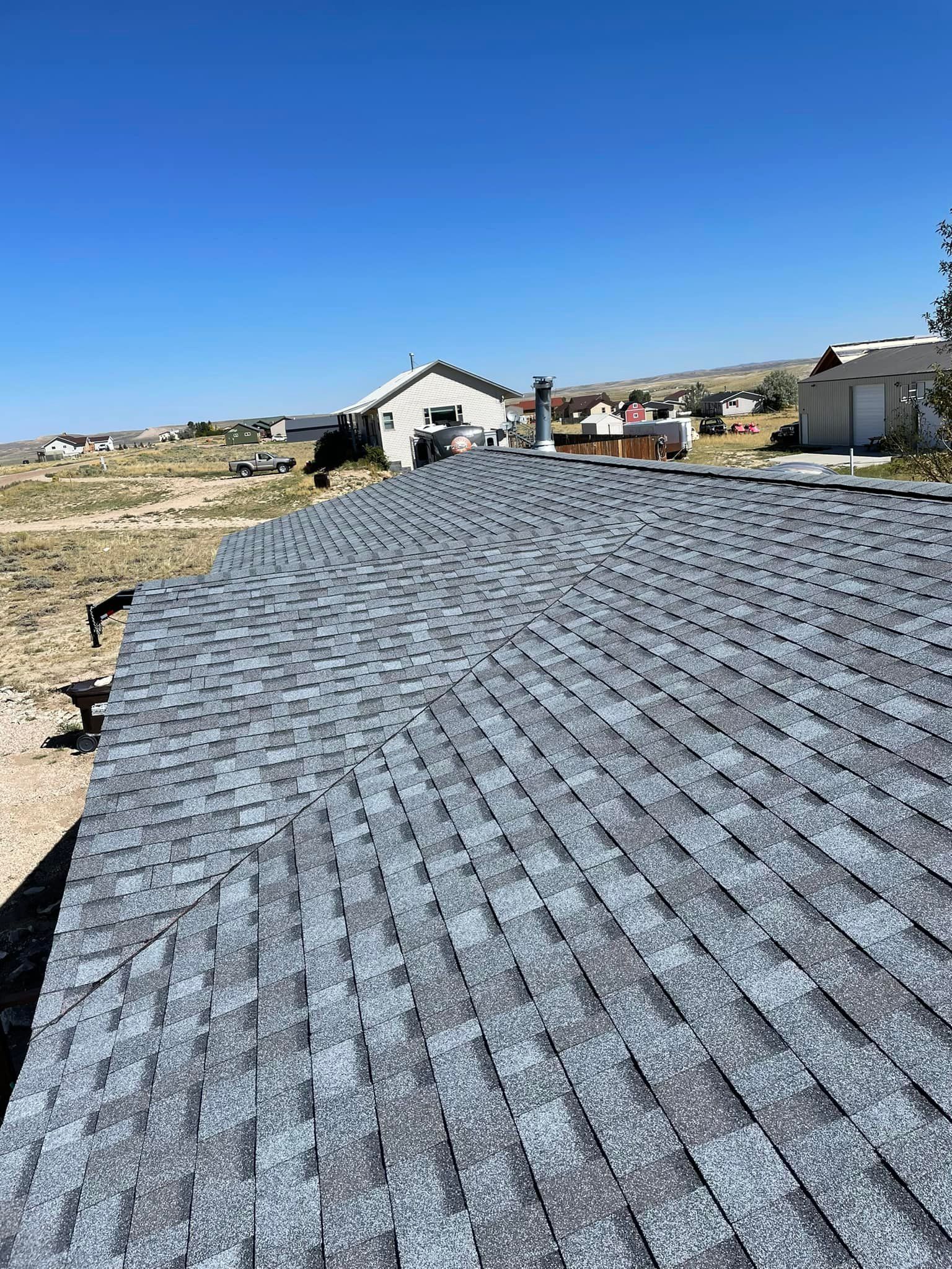 A close up of a roof with a blue sky in the background.