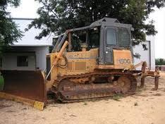 A bulldozer is parked in front of a house.