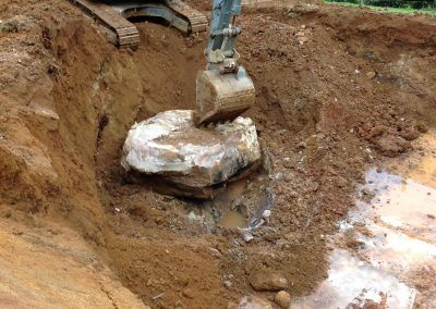 A person is using an excavator to dig a hole in the ground.