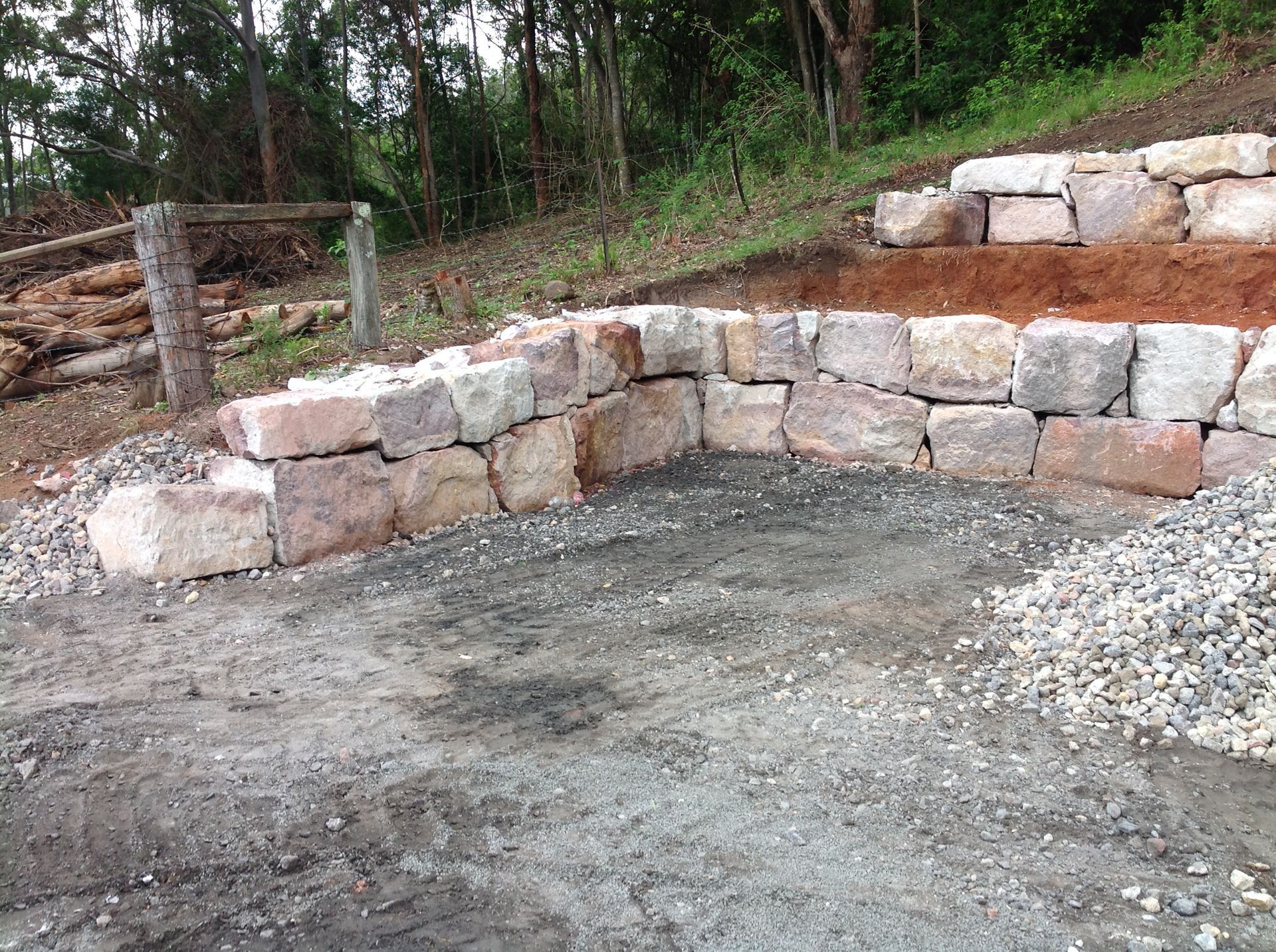 A yellow excavator is digging a hole in the dirt.