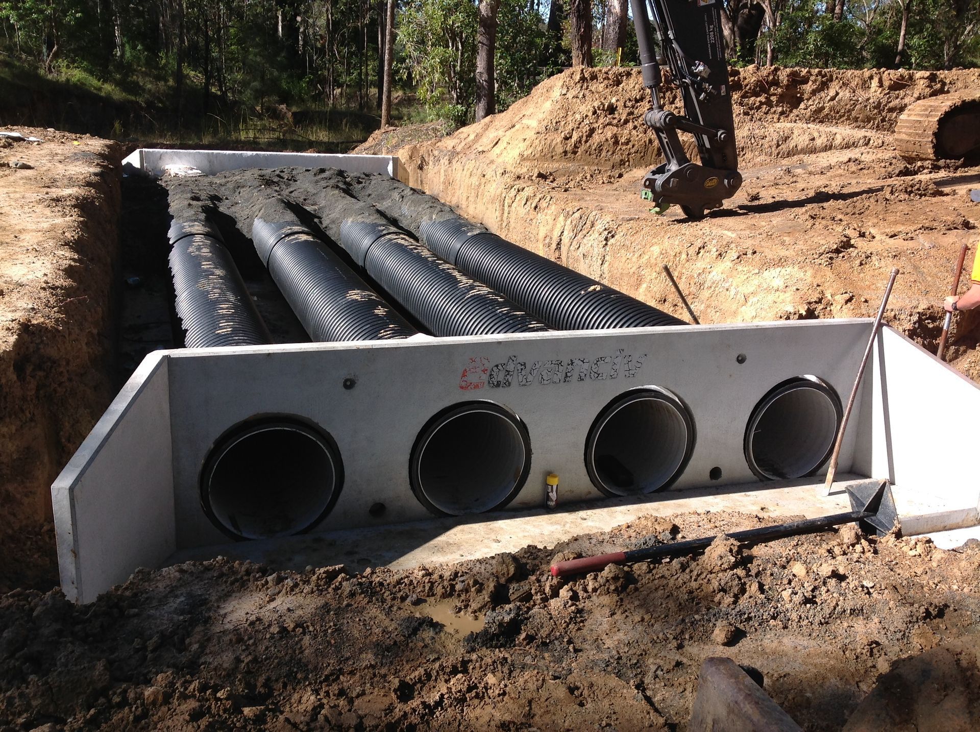 A yellow and black volvo excavator is digging in the dirt