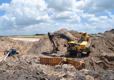 A volvo excavator is digging a hole in the dirt.