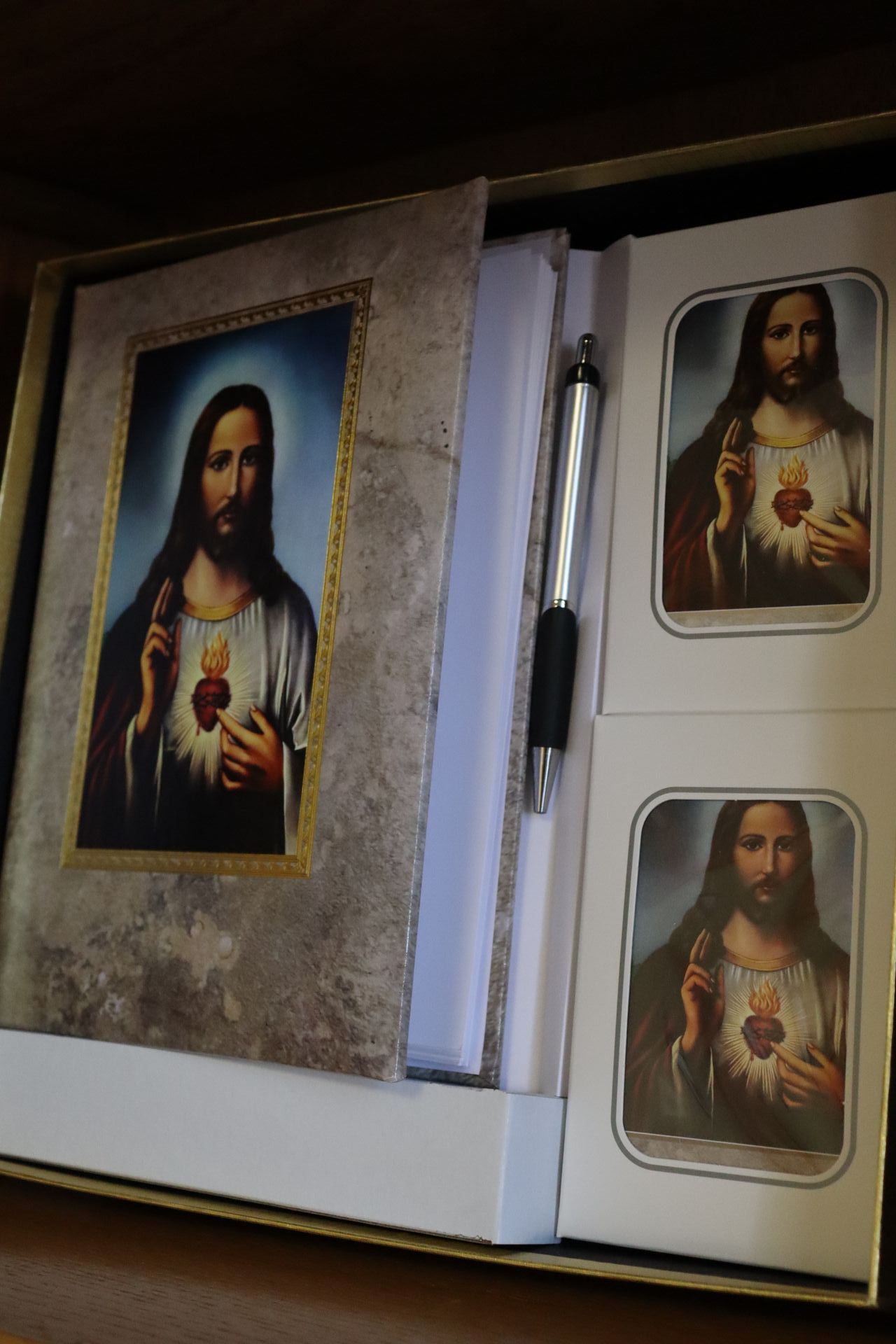 A box with a picture of jesus and a pen