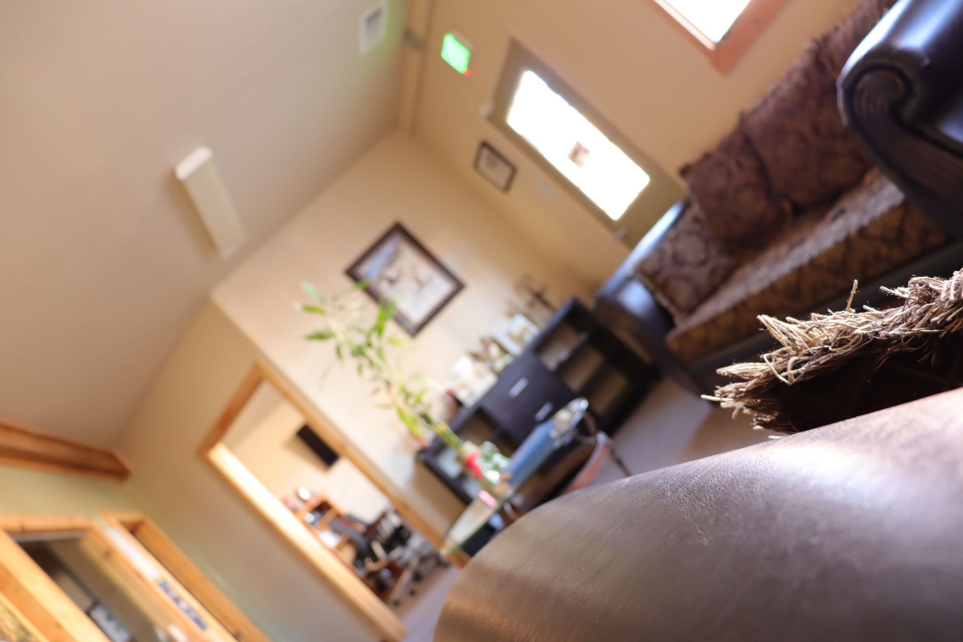 A living room with a couch and a clock on the wall
