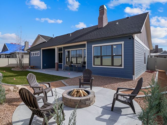 There is a fire pit in the backyard of a house.