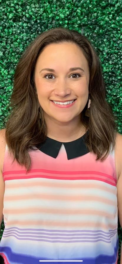 Portrait of a smiling woman in a pink striped top against a green glittery background