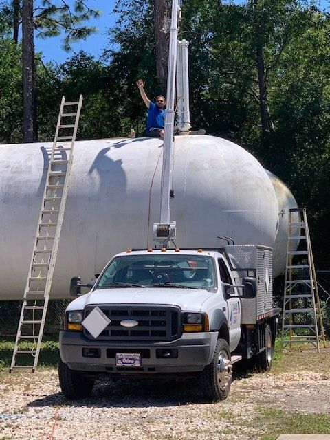 Man Sitting On Storage Tank - Gainesville, FL - Davis Gas Company Inc.