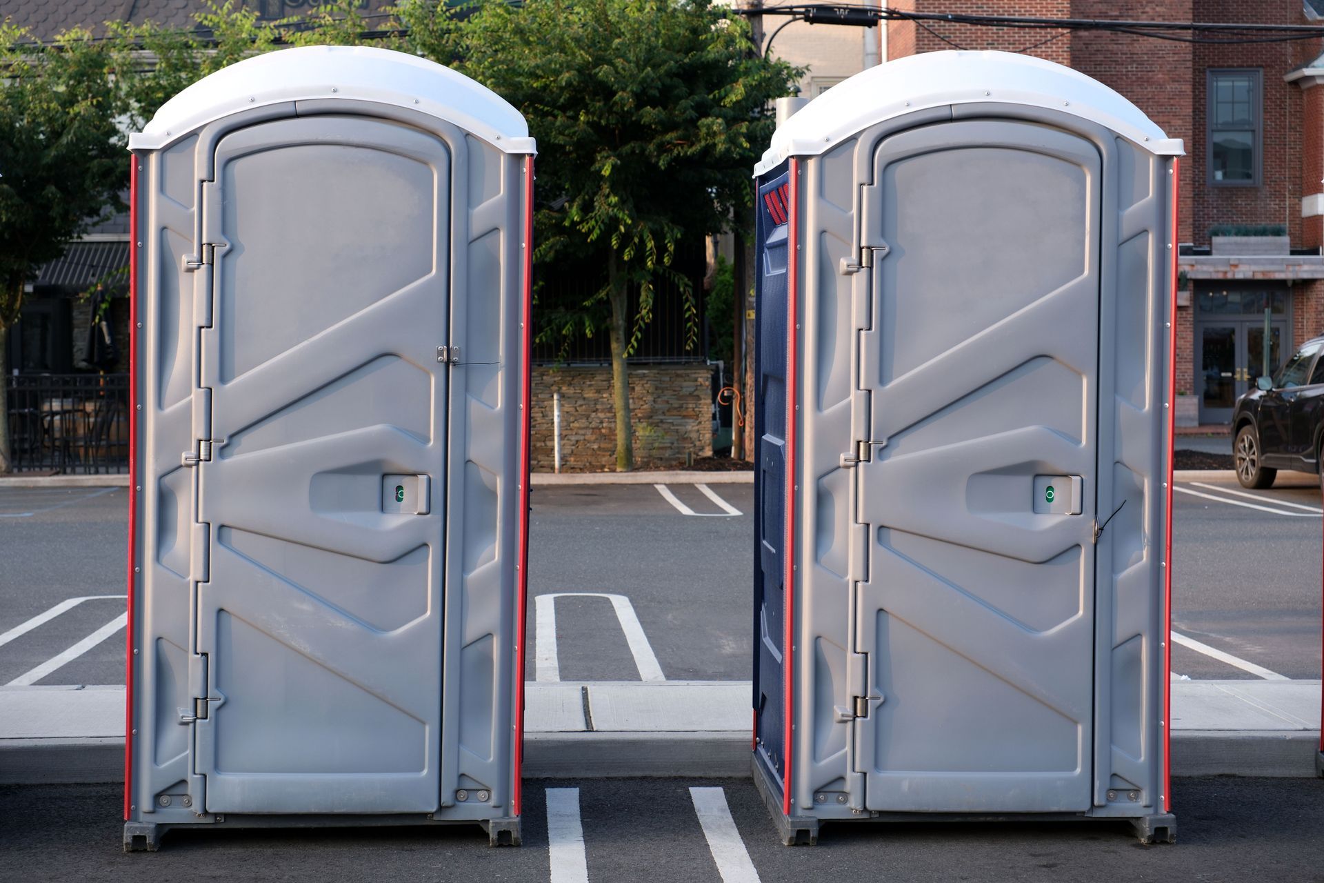 Portable restrooms lined up for an event in the parking lot Portable restrooms lined up for an event in the parking lot