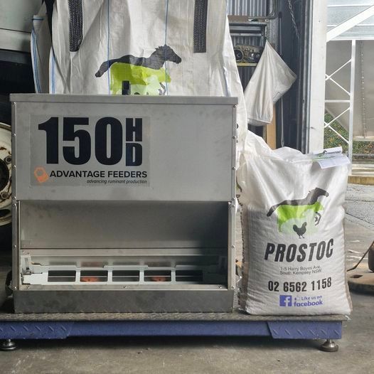 A Metal 150HD Advantage Feeders Box Beside a Prostoc Feed Bag — Prostoc In South Kempsey, NSW