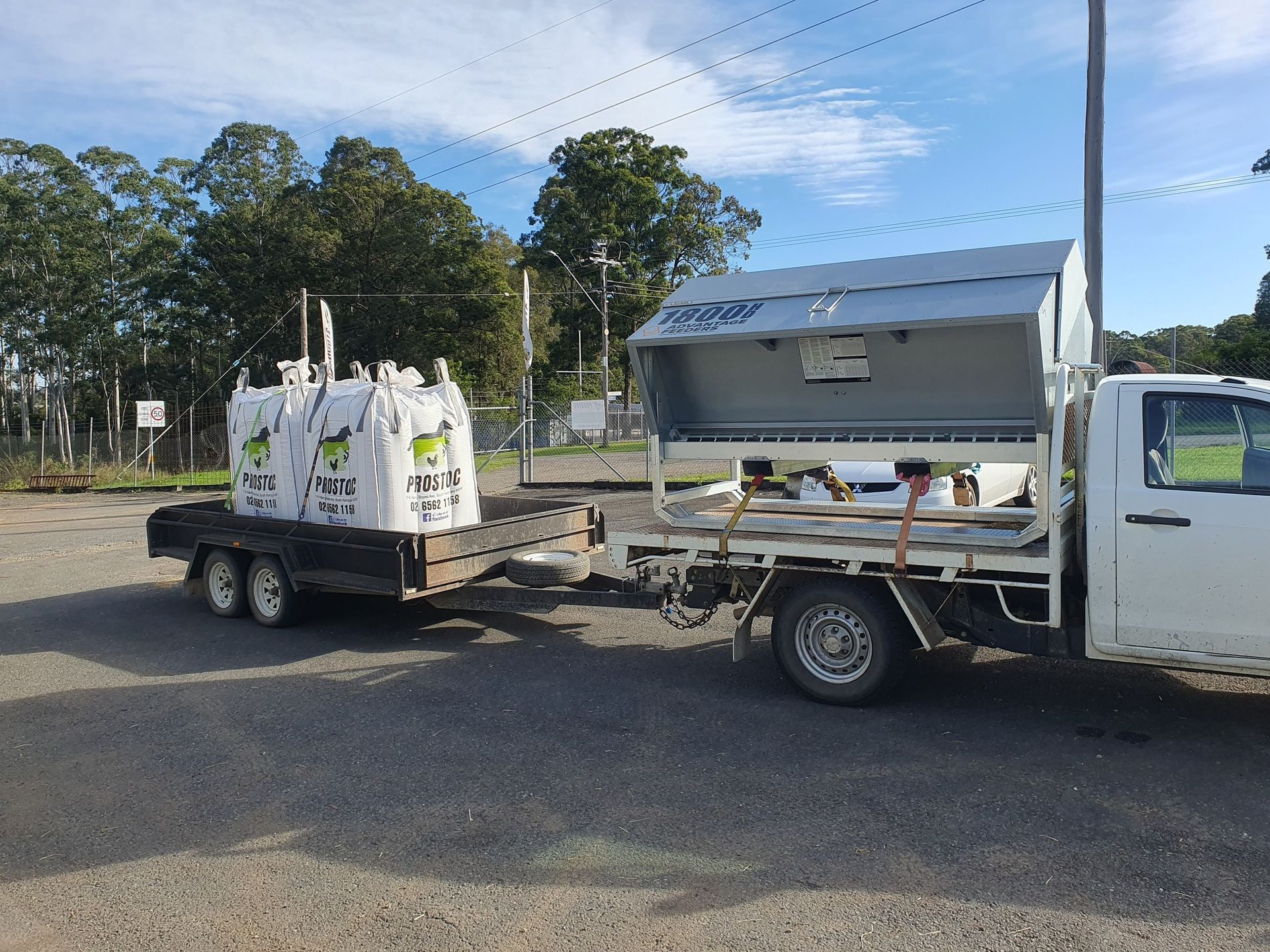 White Truck Towing a Trailer Loaded With Large White Containers — Prostoc In Bellingen, NSW