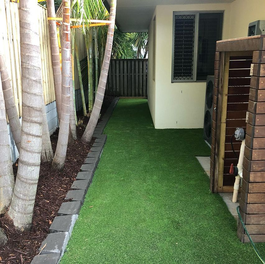 A Fenced in Yard with a Lush Green Lawn — HMJ Landscapes in Broadbeach, QLD