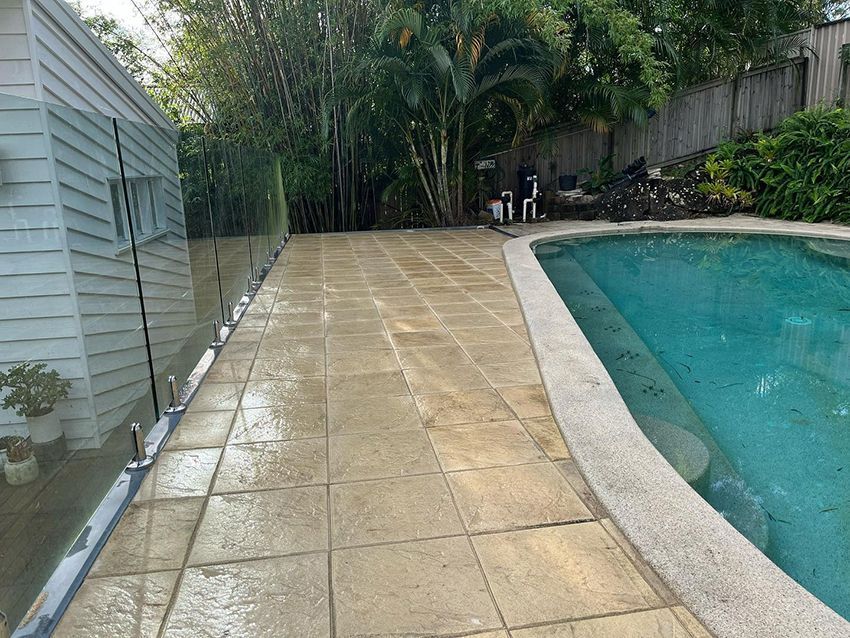 A Swimming Pool with a Tiled Walkway — HMJ Landscapes in Broadbeach, QLD