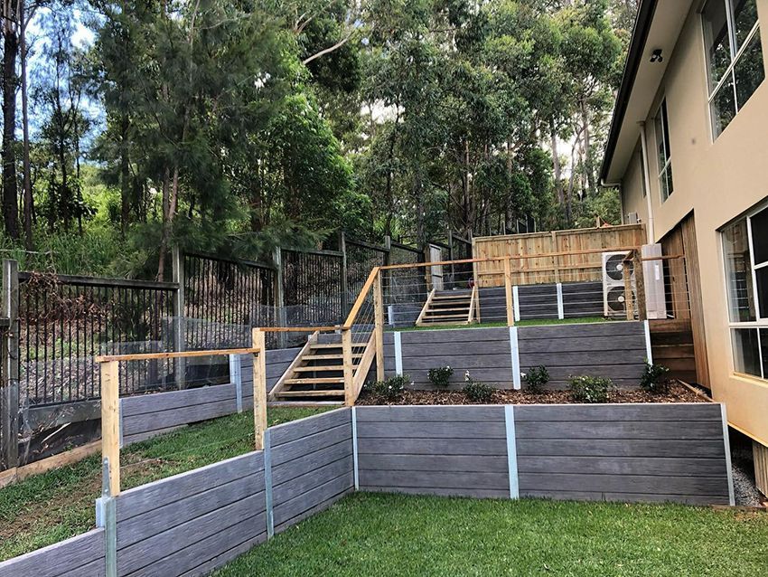 A House with a Fence and Stairs in Front of It — HMJ Landscapes in Broadbeach, QLD