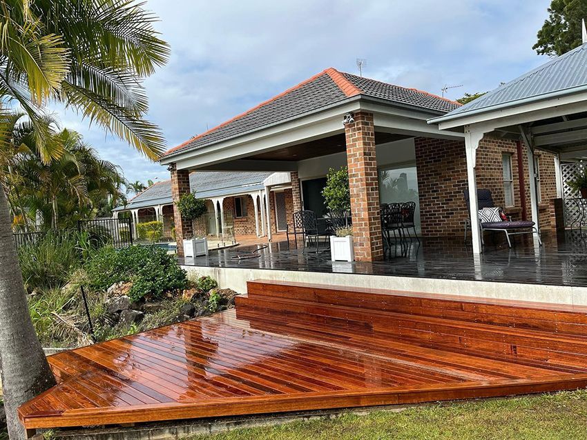 There is a Large Wooden Deck in Front of a House — HMJ Landscapes in Broadbeach, QLD