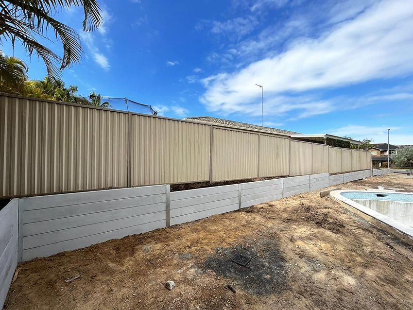 A Fence is Surrounding a Pool — HMJ Landscapes in Robina, QLD