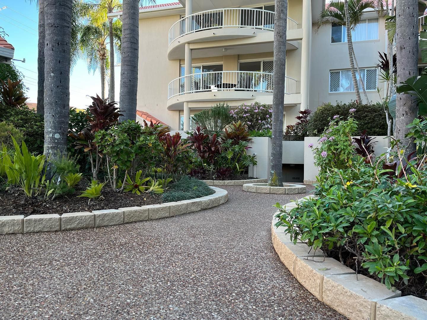 A Man is Spreading Concrete on a Sidewalk with a Rake — HMJ Landscapes in Broadbeach, QLD