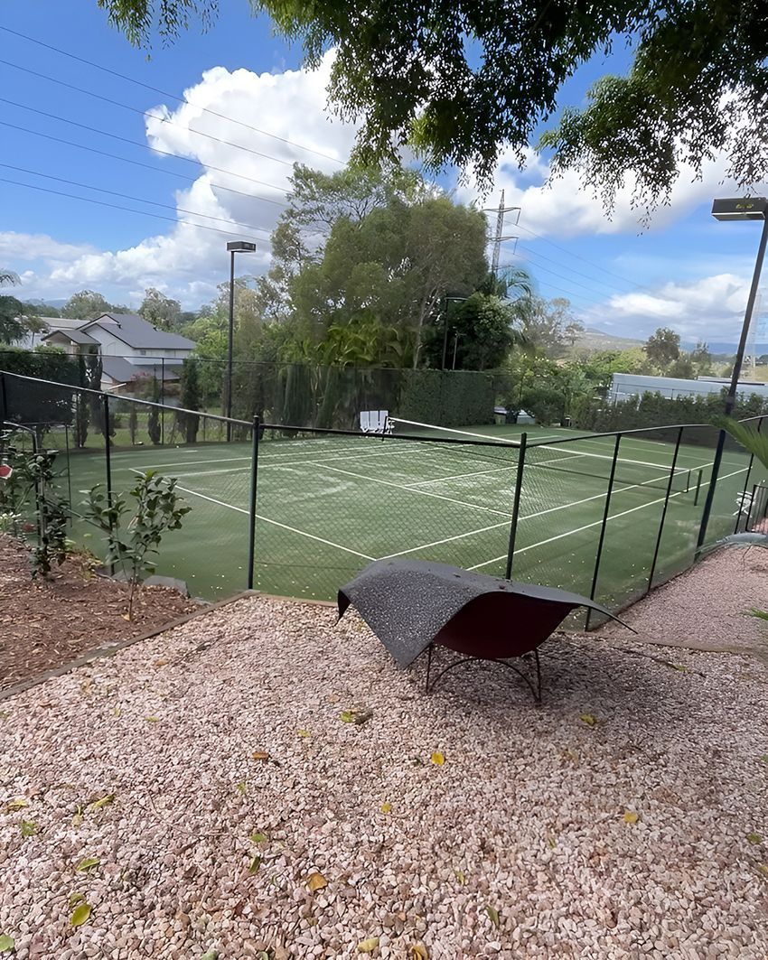 A Wheelbarrow in Front of a Tennis Court — HMJ Landscapes in Hope Island, QLD