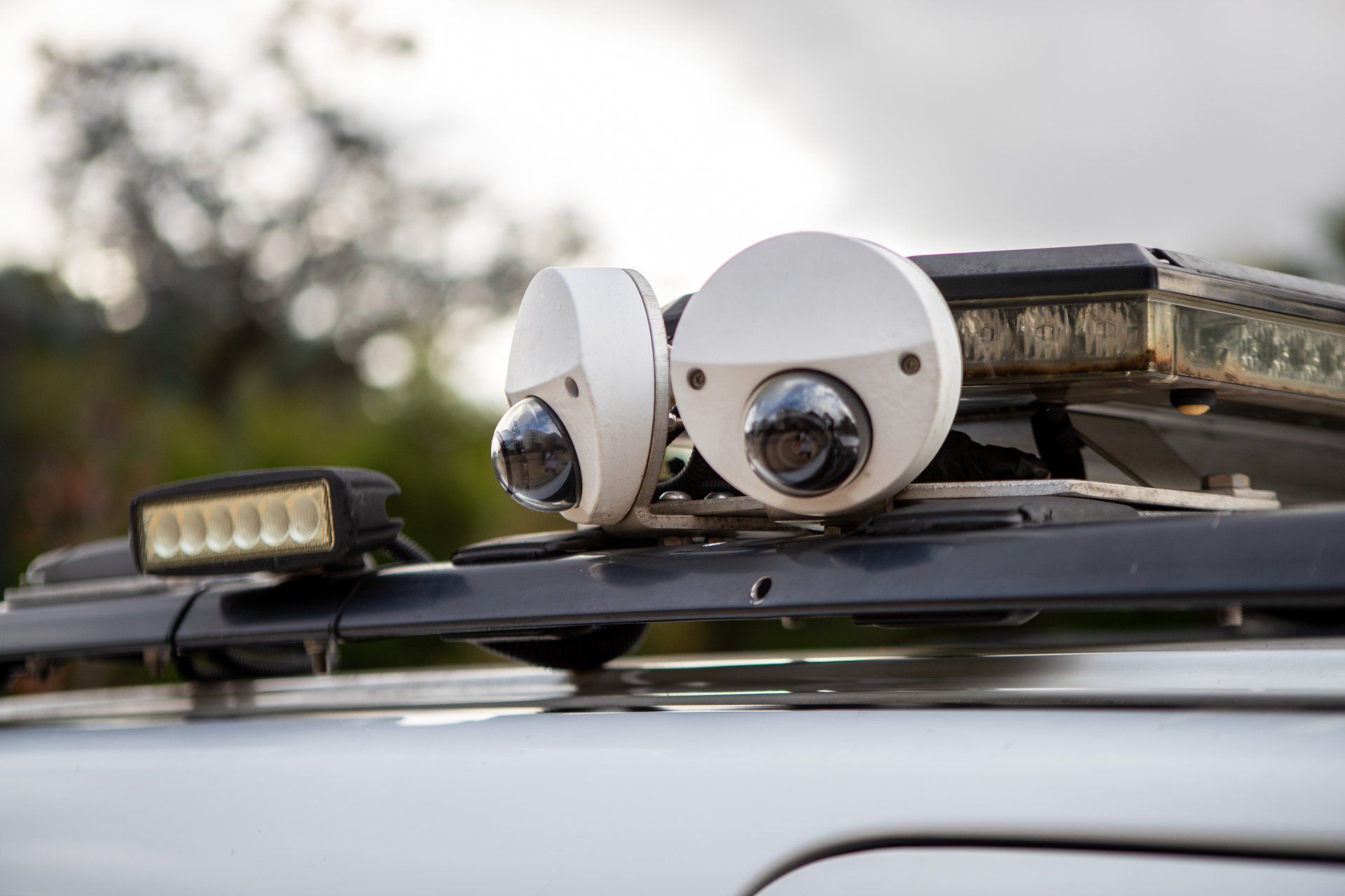 There are two cameras on the roof of a car.
