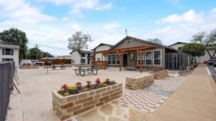 A small house with a picnic table in front of it.