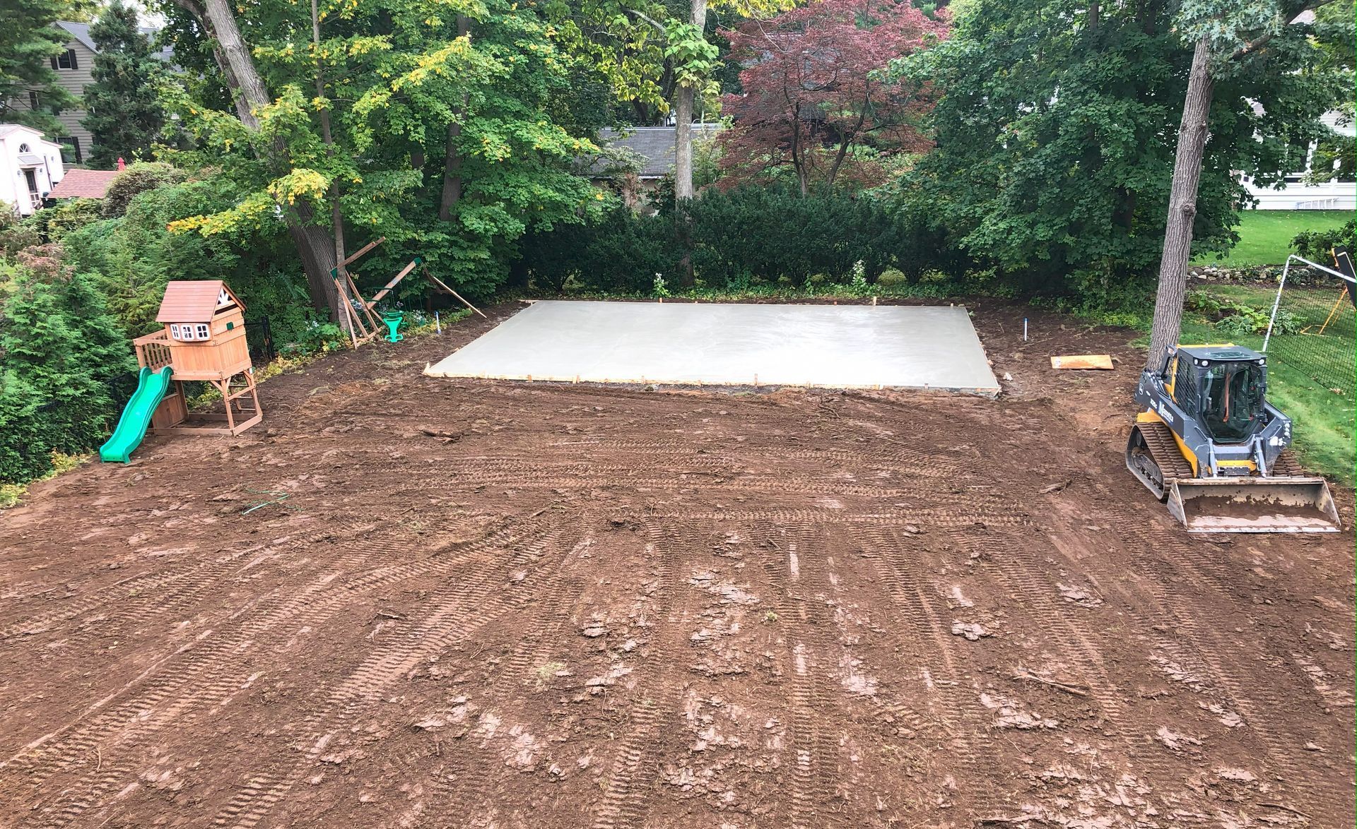 Excavation Being Done With Two Marotta Corp Machines In Front Of Garage