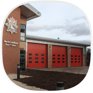 A fire station with red industrial doors