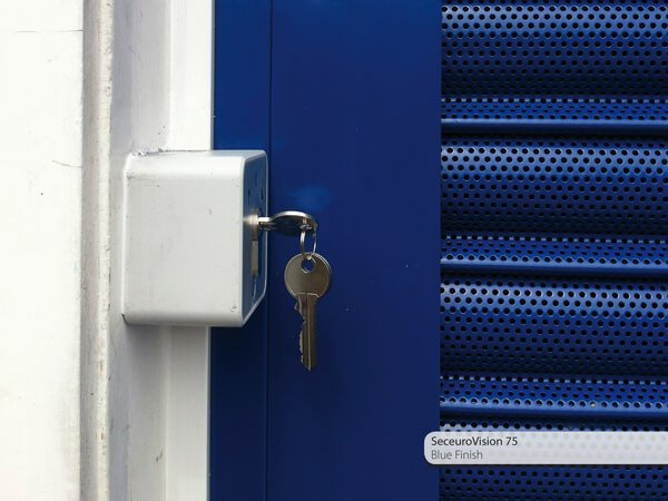 close up of a key locking a roller shutter door