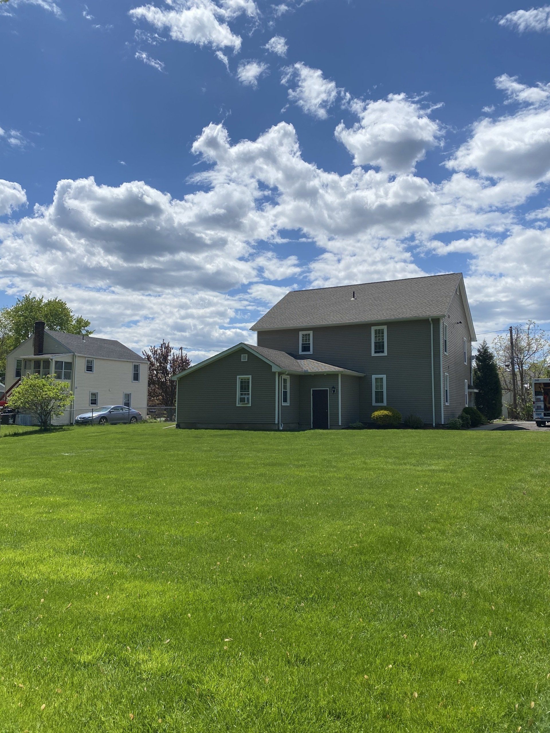 Grassy area in front of large house — Vernon, CT — A1 Properties