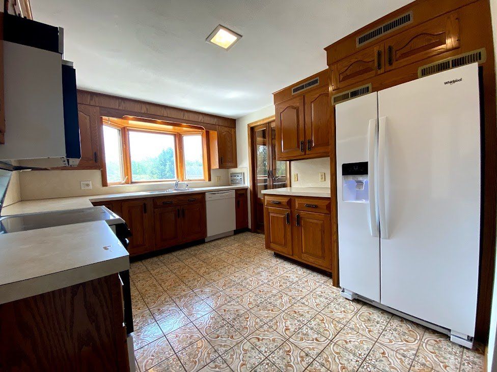 Kitchen showing cabinets and refrigerator — Vernon, CT — A1 Properties