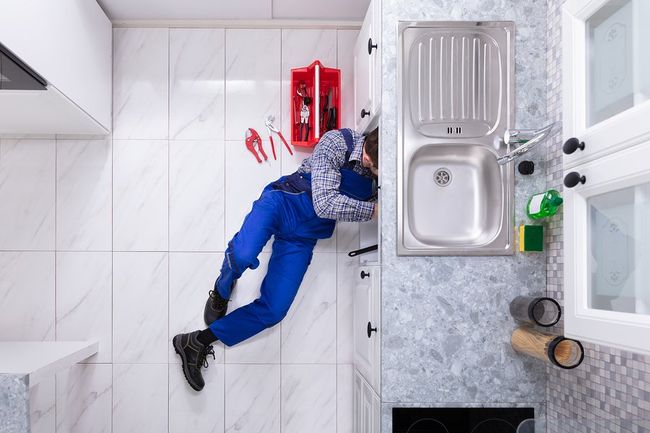man repairing the sink