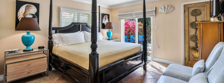 There is a four poster bed in the middle of the room.