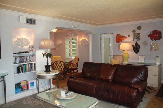 A living room with a brown leather couch and a coffee table