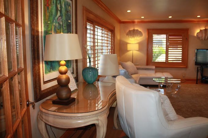 A living room with a couch , chair , table and lamps