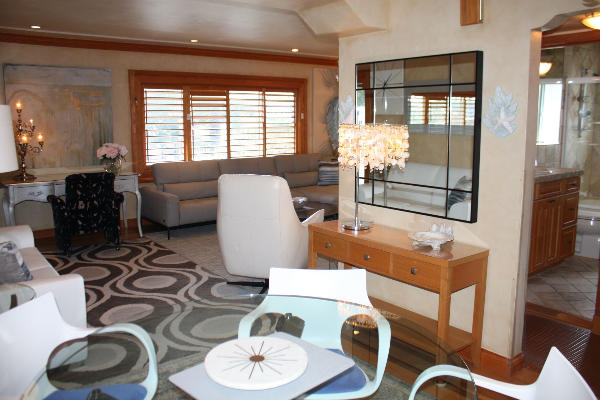 A living room filled with furniture and a large mirror