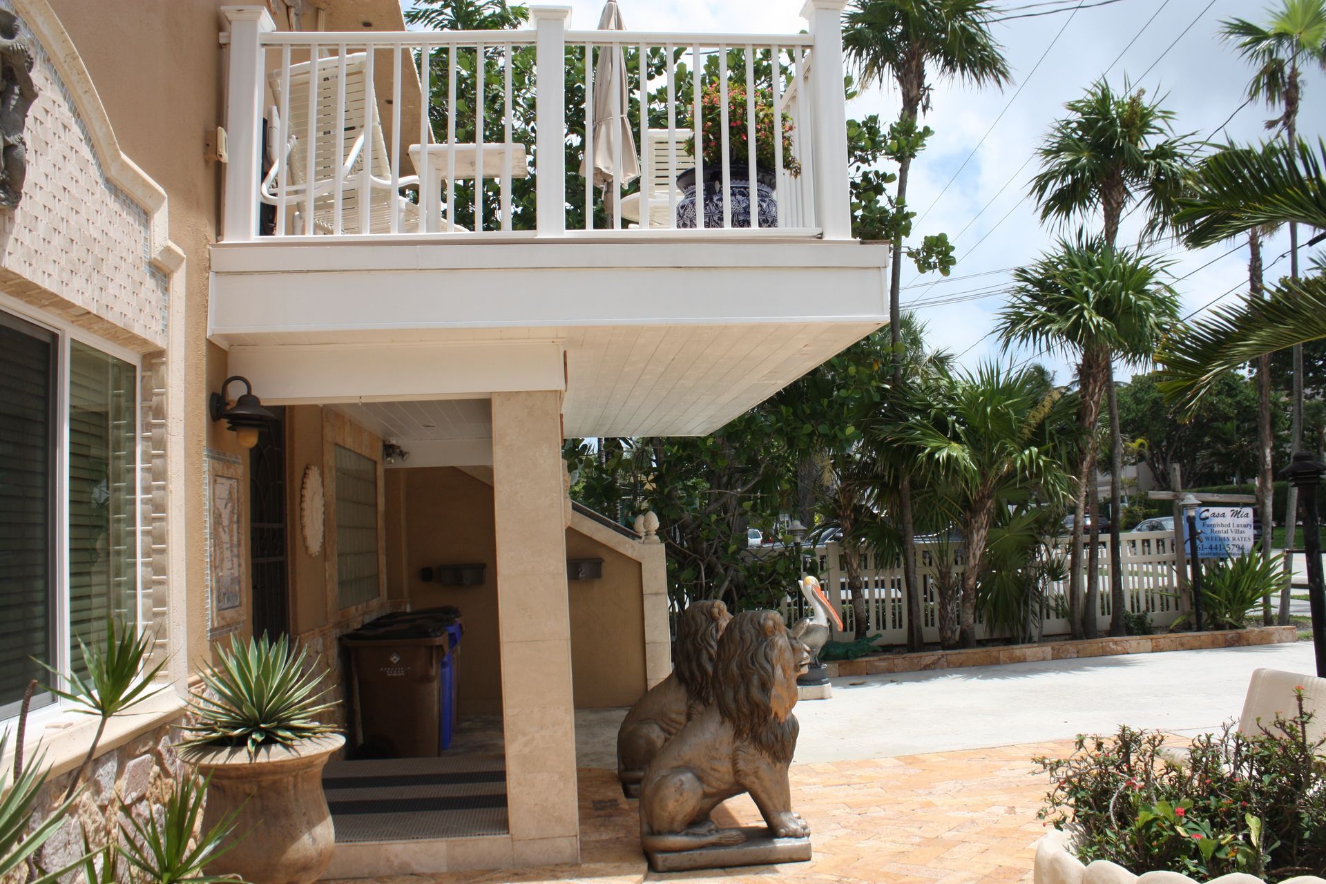 A statue of a lion sits on the porch of a house