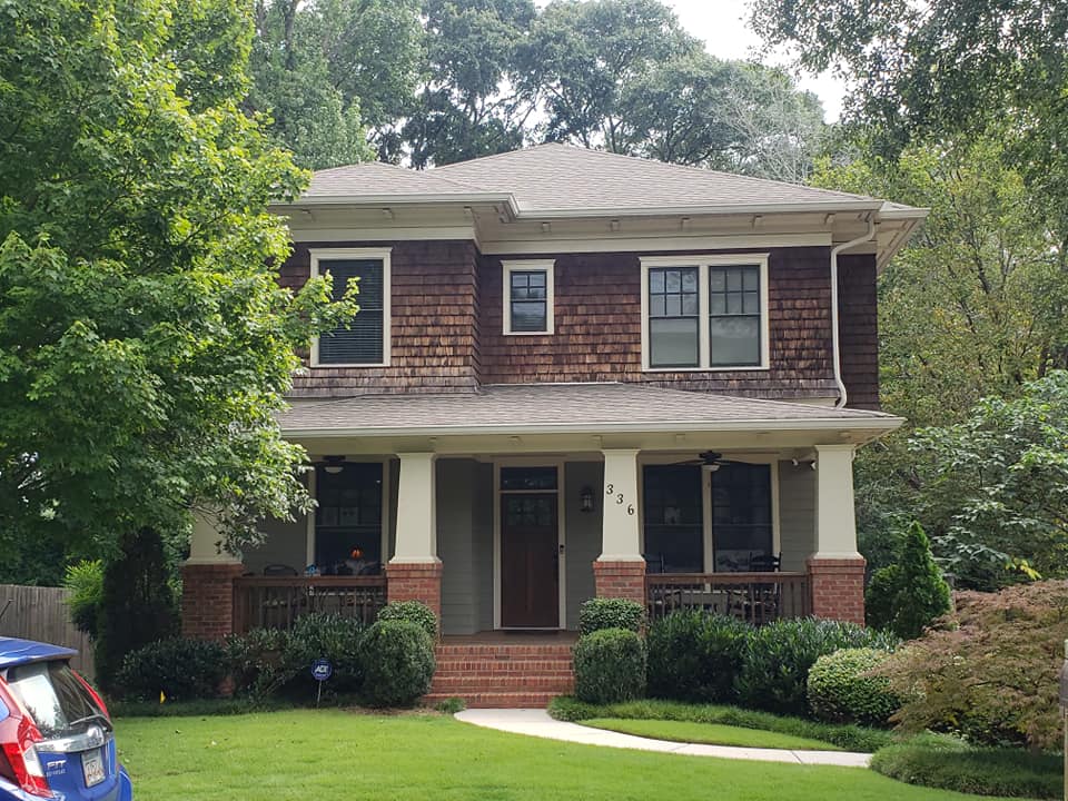 red brick house with white pillars worked on by Total Roof Solutions in Atlanta, Georgia