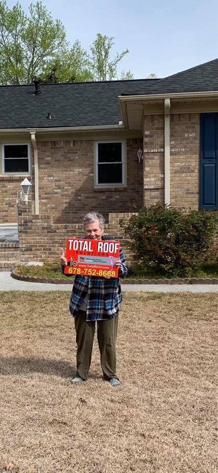women in blue plaid gets her home roof repair from Total Roof Solutions McDonough, GA