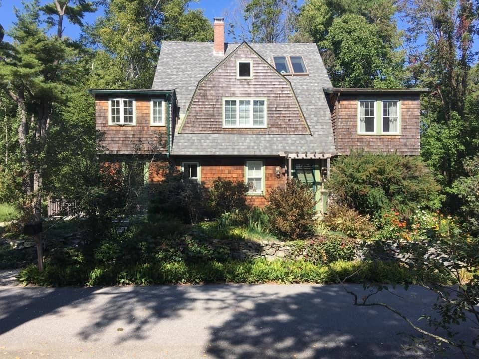 Atlanta, GA home with dark colored bricks and grey roof repaired by Total Roof Solutions