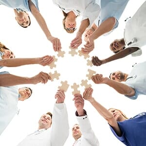 Medical Team Joining Jigsaw Pieces - medical home in Elmhurst, NY