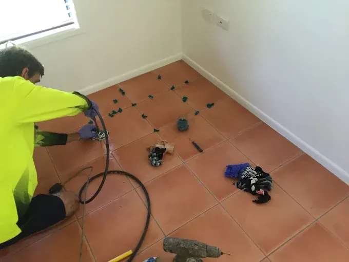 Brown Cabinet Corner on Light Green Tiled Floor — QBSA Waterproofing & Tile Injection in Portsmith, QLD