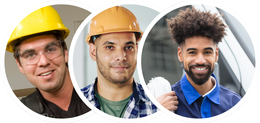 Three men are wearing hard hats and smiling for the camera.