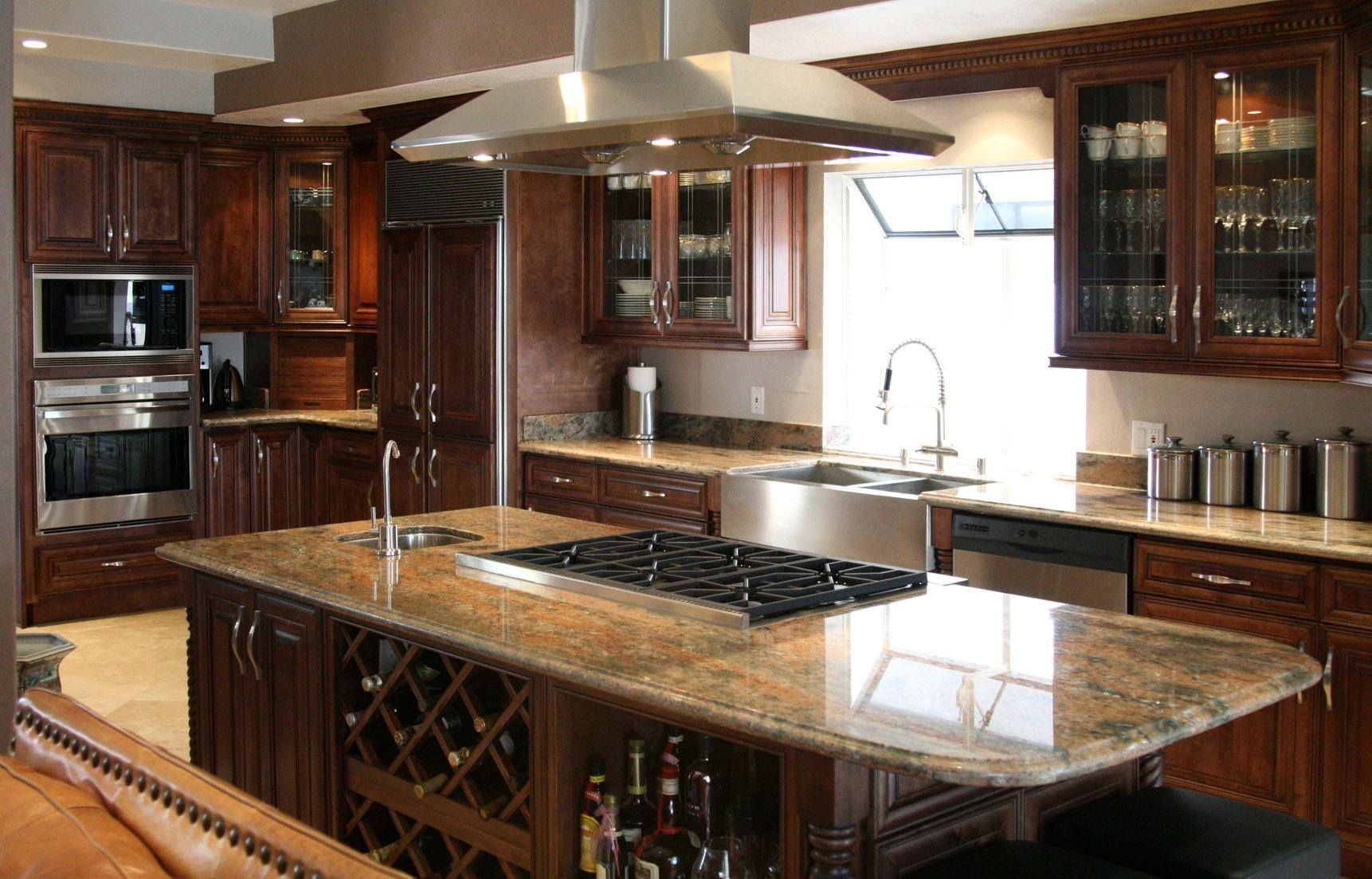 A kitchen with stainless steel appliances and granite countertops