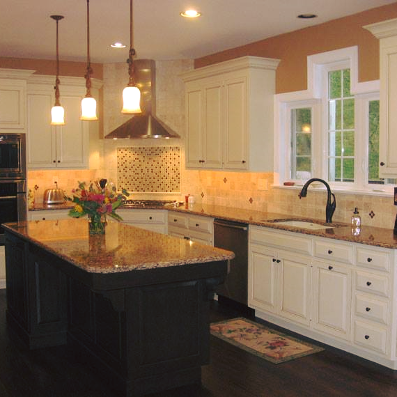 A kitchen with white cabinets and granite countertops
