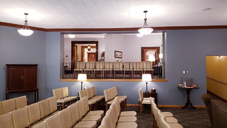 A row of chairs in a room with a balcony