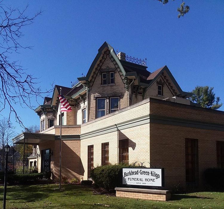 A large brick building with a sign that says funeral road