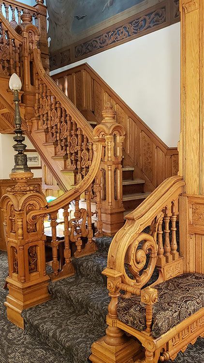 A close up of a wooden staircase in a house.