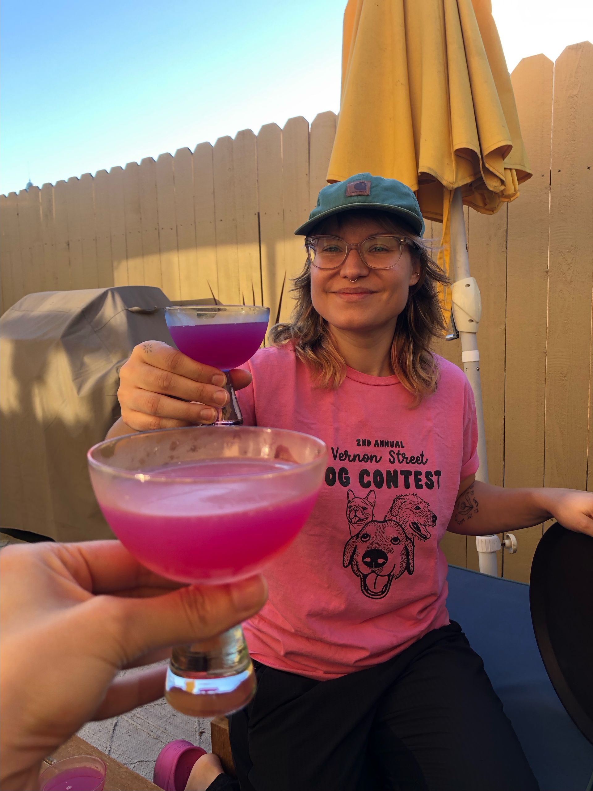 Emily enjoying a custom cocktail with homemade pink pitaya syrup on the patio in Downtown Oakland
