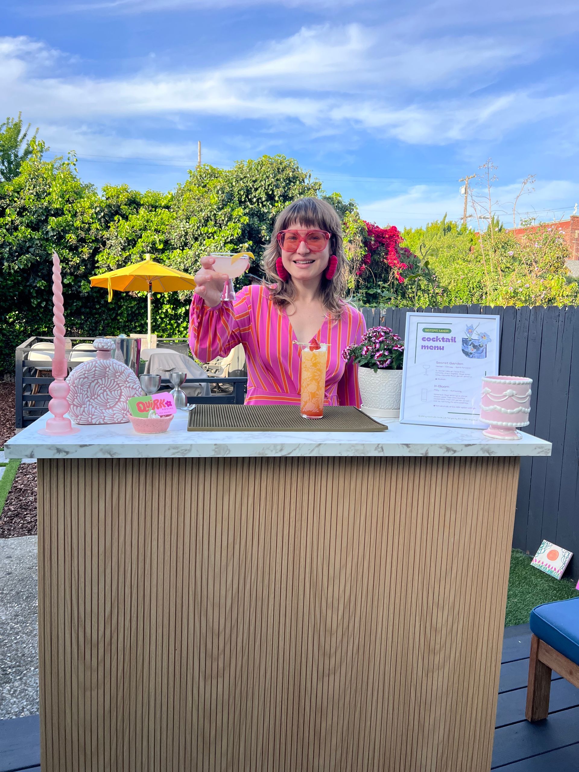 Serving cocktails using our portable bar with a warm oak front and sleek marble finish